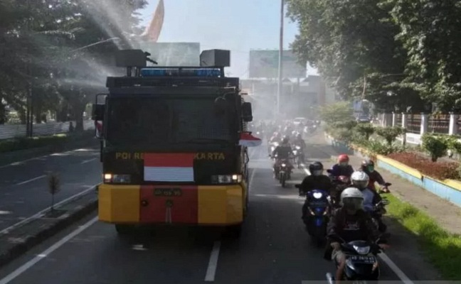 Mobil penyemprot air milik Polres Kota Surakarta melakukan penyemprotan disinfektan di Jalan A. Yani atau depan Terminal Tirtonadi Banjarsari Kota Solo, Jateng,